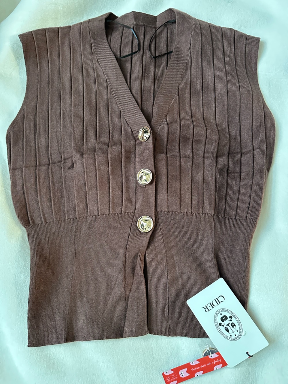 ribbed knit vest lwith decorative gold-tone buttons. - Picture 2 of 6
